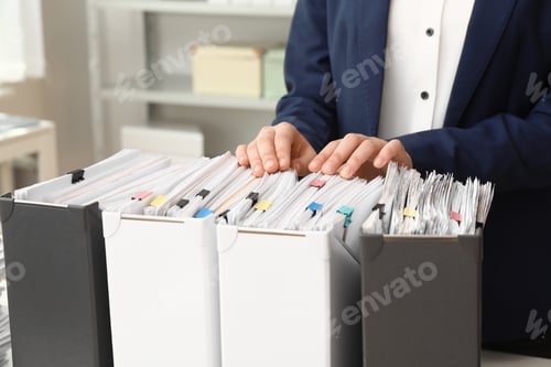 Preview: Woman taking documents from folder in archive, closeup