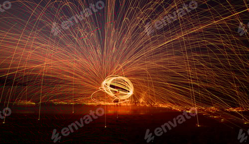 Preview: Fire dancer swing fire dancing show on celebration with dark sky background.