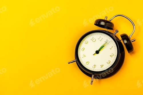 Preview: Black alarm clock with yellow background.