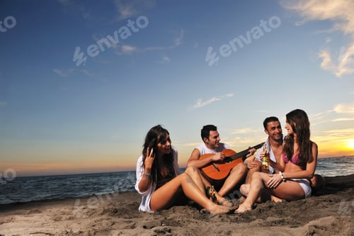 Preview: Happy Young Friends Group Have Fun And Celebrate While Jumping And Running On The Beach At The