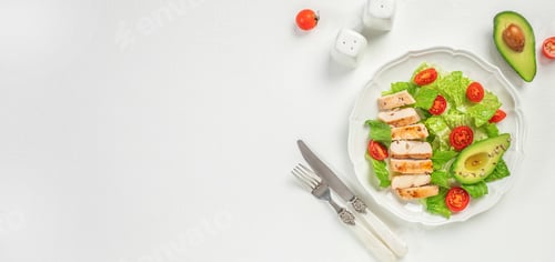 Preview: Grilled chicken breast, fillet and fresh vegetable salad of lettuce, tomato and avocado on a white