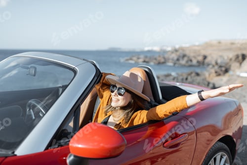 Preview: Woman driving a cabriolet near the ocean