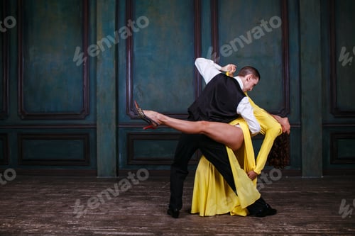 Preview: Man and woman in black dress dance tango