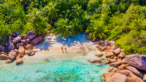 Preview: Praslin Seychelles tropical island with withe beaches and palm trees, couple men and women mid age