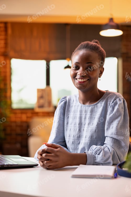 Preview: Smiling black woman at home office desk
