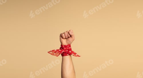 Preview: A man's hand, with a red bandana with white polka dots on his wrist. Feminismus Them.