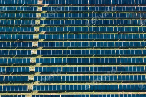 Preview: Aerial view of big sustainable electric power plant with many rows of solar photovoltaic panels