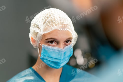 Preview: a doctor surgeon in a special uniform preparing instruments before surgery in an operating room