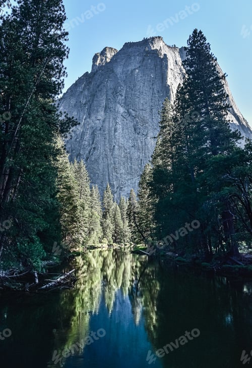 Preview: Trees along a river framing a mountain in the background