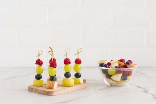 Preview: Fresh Fruit Skewers and Salad on Marble Table