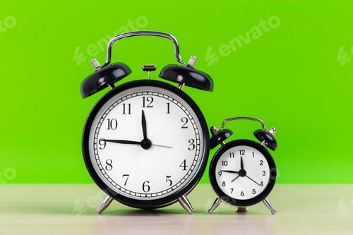 Preview: Vintage black alarm clock on a bright green background