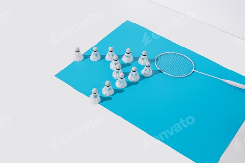 Preview: composition with badminton racket and shuttlecocks on blue paper
