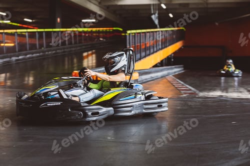 Preview: Woman Driving Go-Kart on Indoor Track in Racing Action