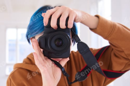 Preview: world photography day concept. woman portrait with camera in hands, photoghrapher in work