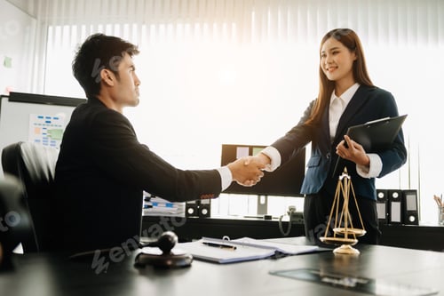 Preview: Judge and client shaking hands and lawyers discussing contract papers after adviced