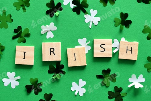 Preview: Saint Patrick Day green background with green & white shamrock confetti wooden tiles spelling IRISH