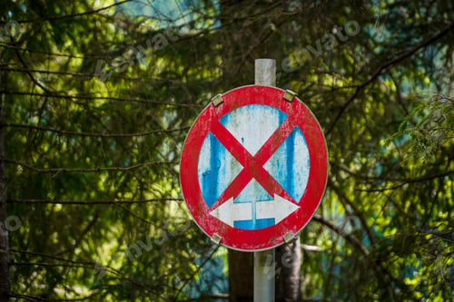 Preview: Weathered no entry road sign with trees in the background