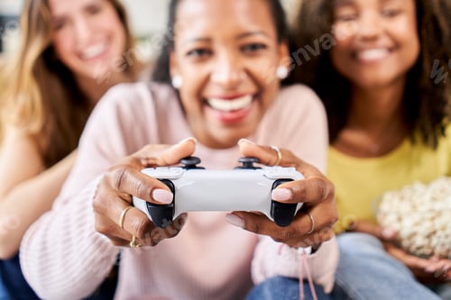 Preview: Group of young friends play video games together at home. Only women gamers