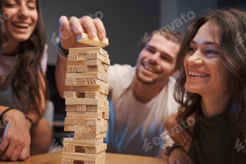 Preview: Group of friends playing table games at home