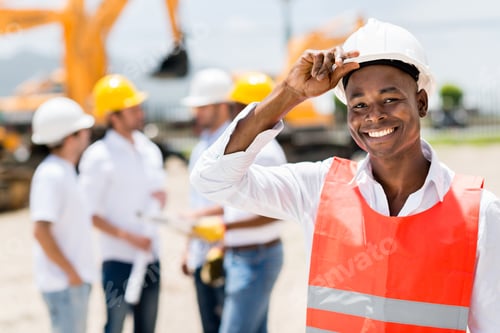 Preview: Happy Male Architect At A Building Site Wearing A Helmet