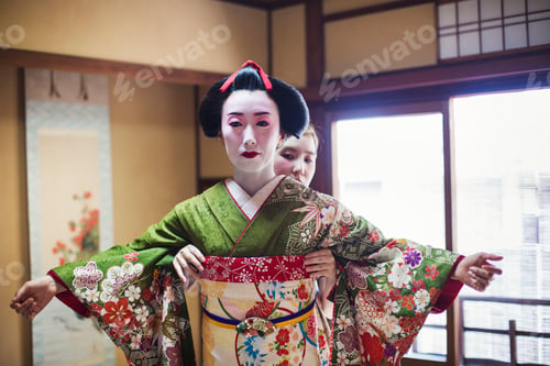 Preview: A geisha being dressed in the traditional kimono
