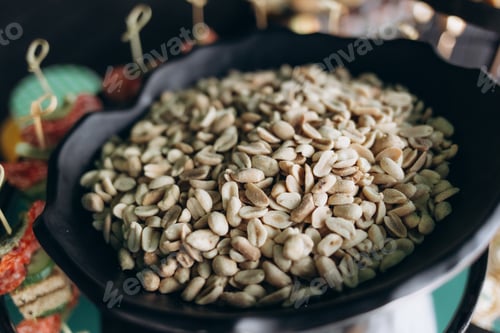 Preview: Close-Up View of Salted Peanuts in a Black Tray at a Buffet