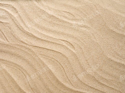 Preview: Beach sand background with natural wave pattern. Summer background of beach sand with small stones