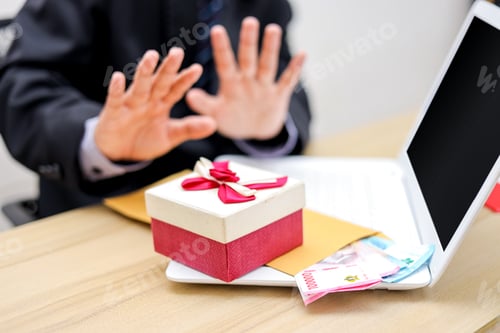 Preview: Hands Refuse Money and a Present on a Desk, Symbolizing Anti-Corruption and Ethical Behavior