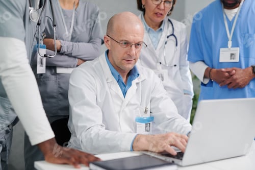 Preview: Doctor showing presentation on laptop