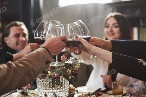 Preview: For our success. Family friends having nice time in beautiful luxury modern restaurant