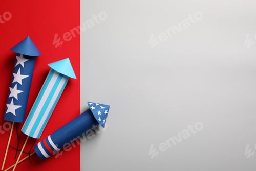 Preview: Firework rockets on color background, flat lay with space for text. Festive decor