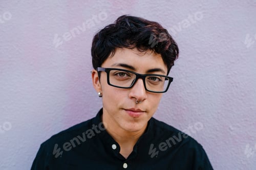 Preview: Close up view of a young transgender man looking at camera.