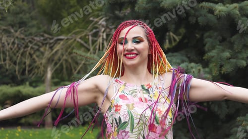 Preview: A girl with a happy smile in a dress with African braids