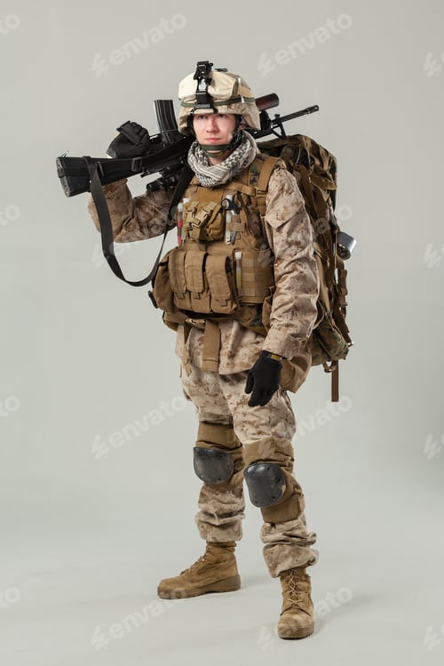 Preview: Soldier stands with weapon and gear in military attire during training session