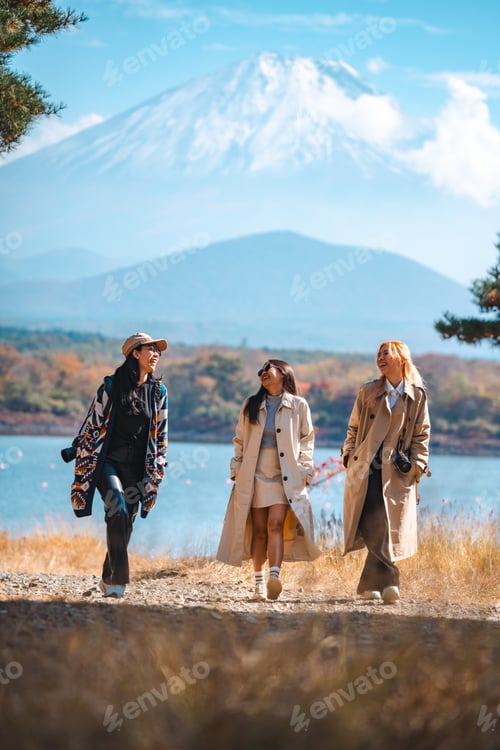 Preview: Happy tourist traveler woman or man enjoying on lake kawaguchiko with mount fuji in japan
