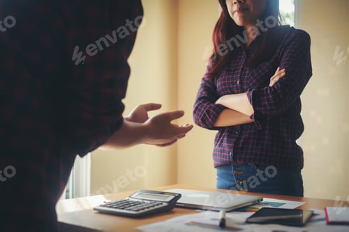 Preview: Serious businessman explaining business planning to business woman.