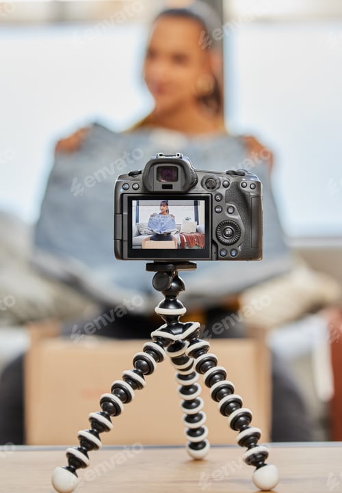 Preview: Shot of a young woman recording a video for her vlog at home