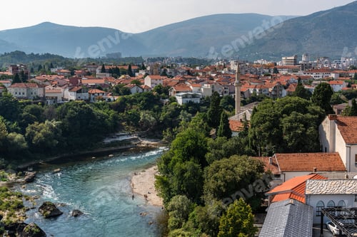 Preview: Neretva River Meandering Through a Lush Green Hillside in Mostar, Bosnia and Herzegovina