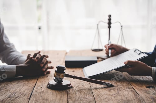 Preview: concept of justice and law A male judge in the courtroom on a wooden table and a male counselor or l