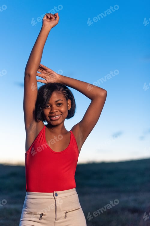 Preview: Vertical portrait of a young black woman posing