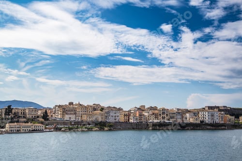 Preview: Corfu island cityscape from the sea with blue waters and sky.