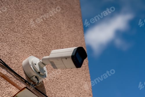 Preview: city landscape against the backdrop of a terracotta wall of a residential building, a surveillance