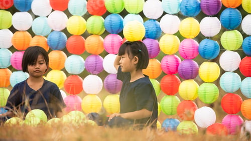Preview: Childhood life in rural Thailand. A small child plays with colorful little hanging lamp