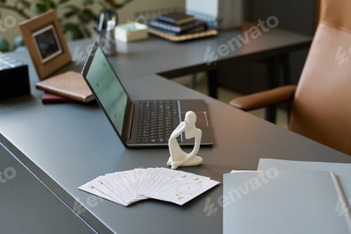 Preview: Psychologist Desk Displaying Tarot Cards and Modern Laptop in Office Setting