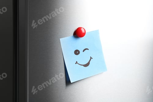 Preview: Note with funny face on refrigerator door
