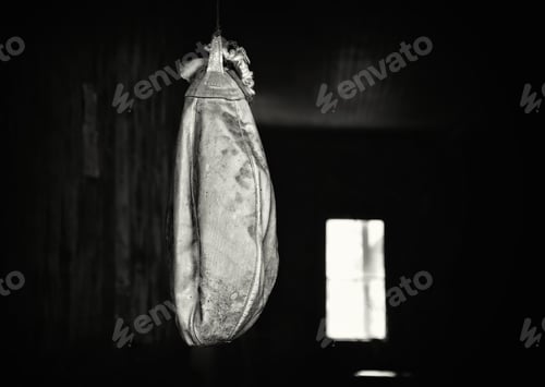 Preview: Dirty punch ball hanging in a abandoned building in dark background