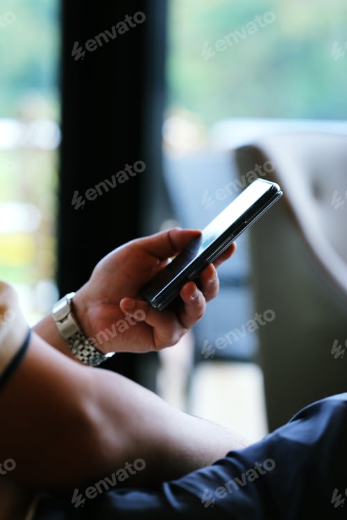 Preview: People using mobile phone while sitting relax at coffee shop closeup blur background