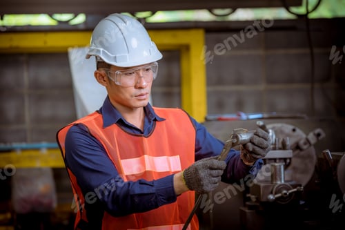 Preview: Industry engineer wearing safety uniform used Vernier caliper to measure the object control operatin