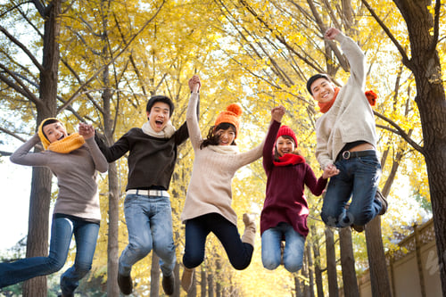 Preview: Friends Playing, Jumping Together in a Park in Autumn