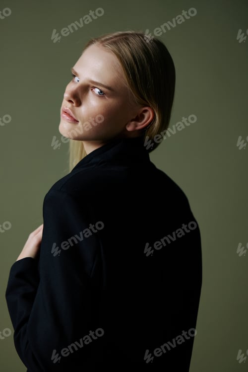 Preview: A beautiful attractive model poses with her back to the camera. Concept photo for clothing brands